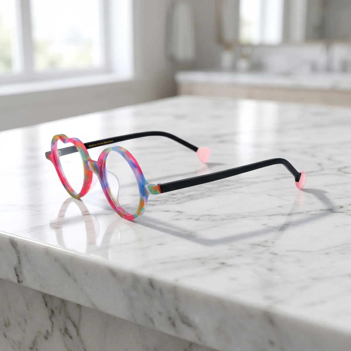 Side view of Rainbow Twist variant, showcasing frame thickness and temple arm structure. Multi-colored design with a swirl of rainbow shades in matte finish.