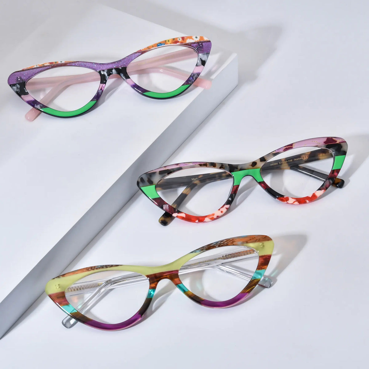Group view of VoyueLens KaleidoCat eyeglasses showing three color variants: Violet Garden (C1), Tortoiseshell Pop (C2), and Sunrise Mirage (C3), arranged diagonally on white background.