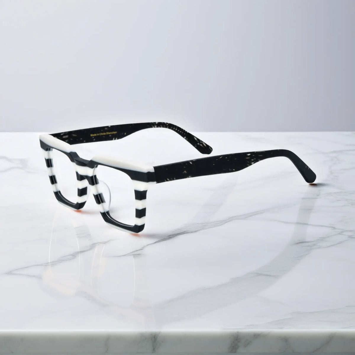 Side view of Zebra Noir eyeglasses in Zebra Noir – black and white striped color block design